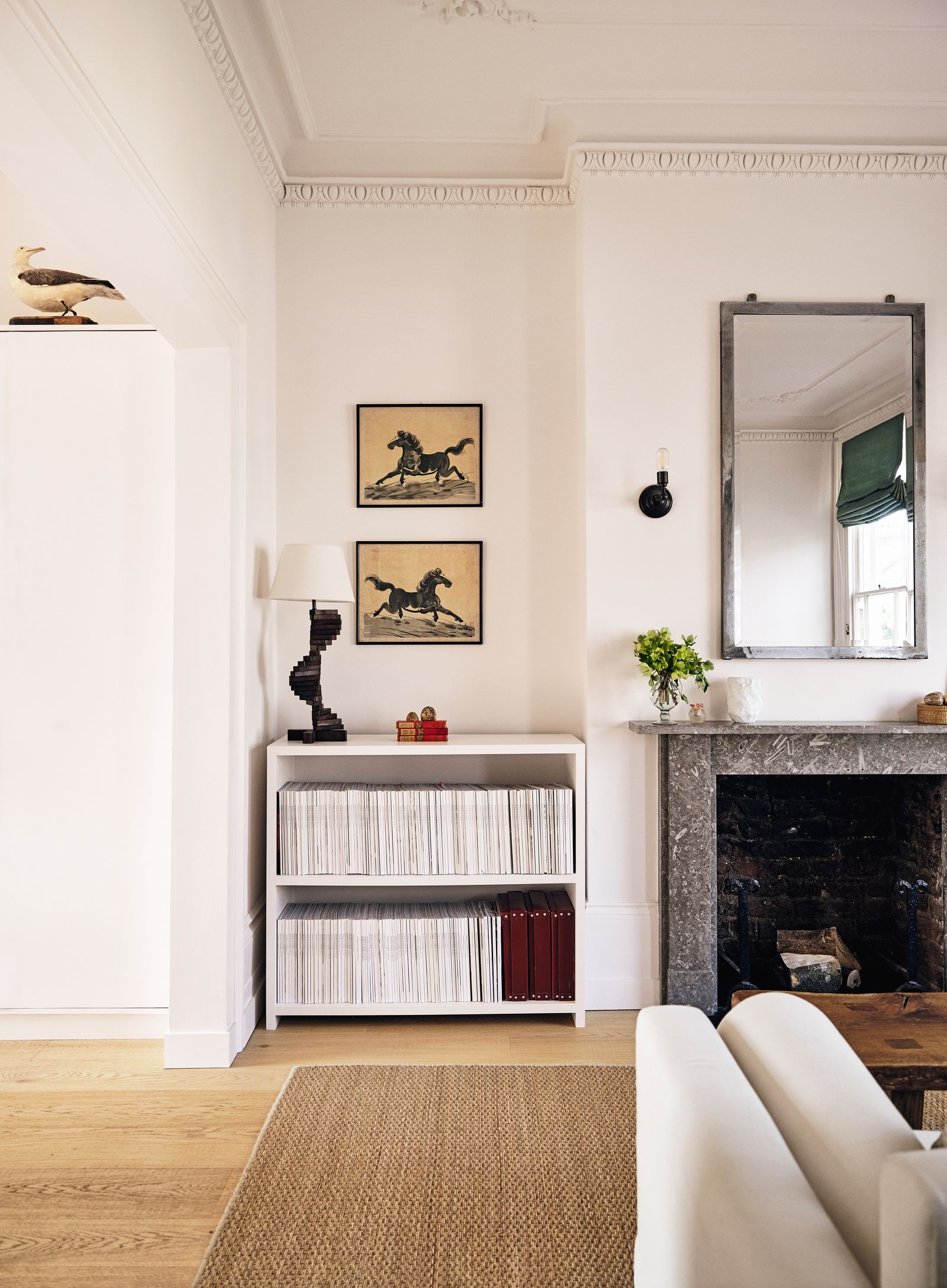 Image may contain Indoors Interior Design Home Decor Corner Lamp Art Painting Plant Fireplace Furniture and Rug