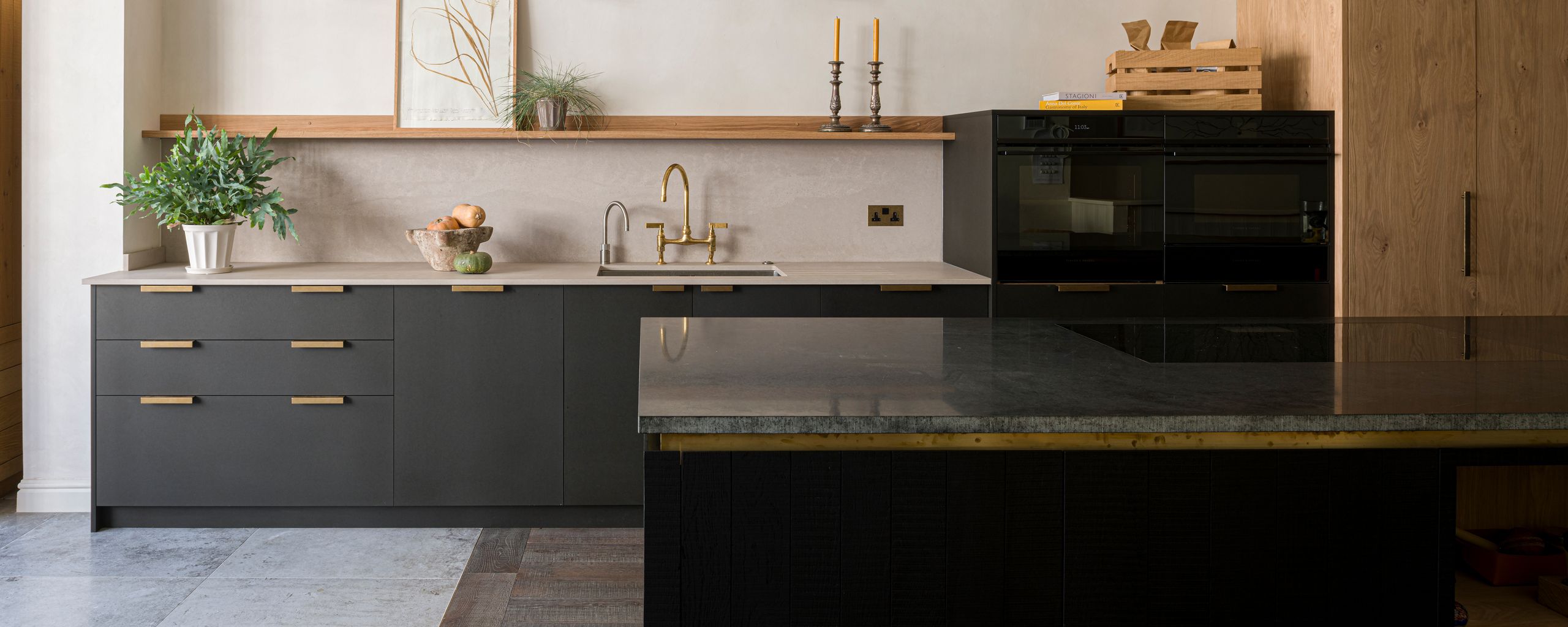 Image may contain Indoors Kitchen Interior Design Plant Kitchen Island Sink and Sink Faucet