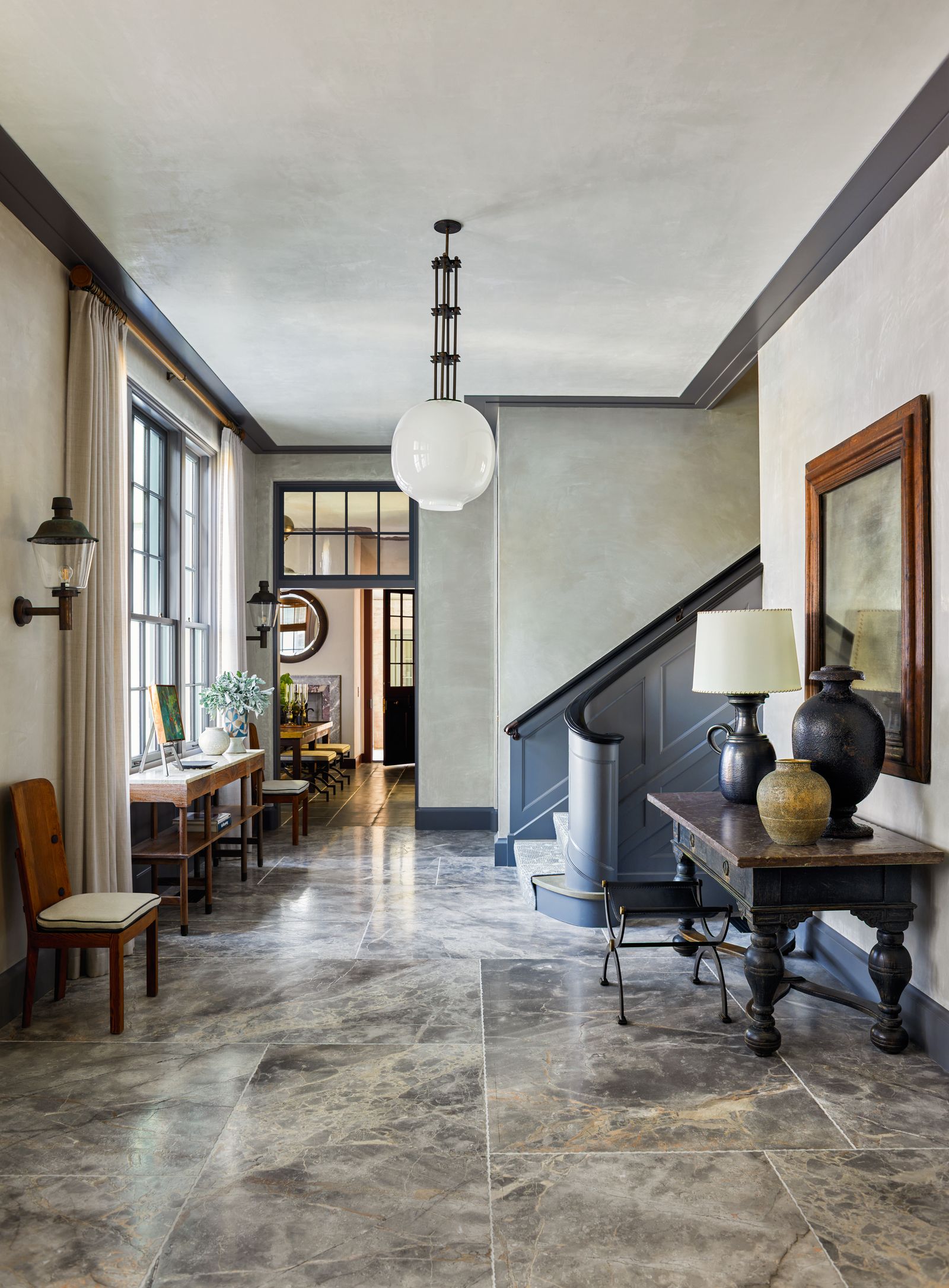 Image may contain Floor Flooring Lamp Chair Furniture Desk Table Plant Indoors Architecture Building and Foyer