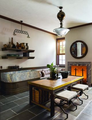 Image may contain Indoors Interior Design Lamp Plant Desk Furniture Table Architecture Building and Dining Room